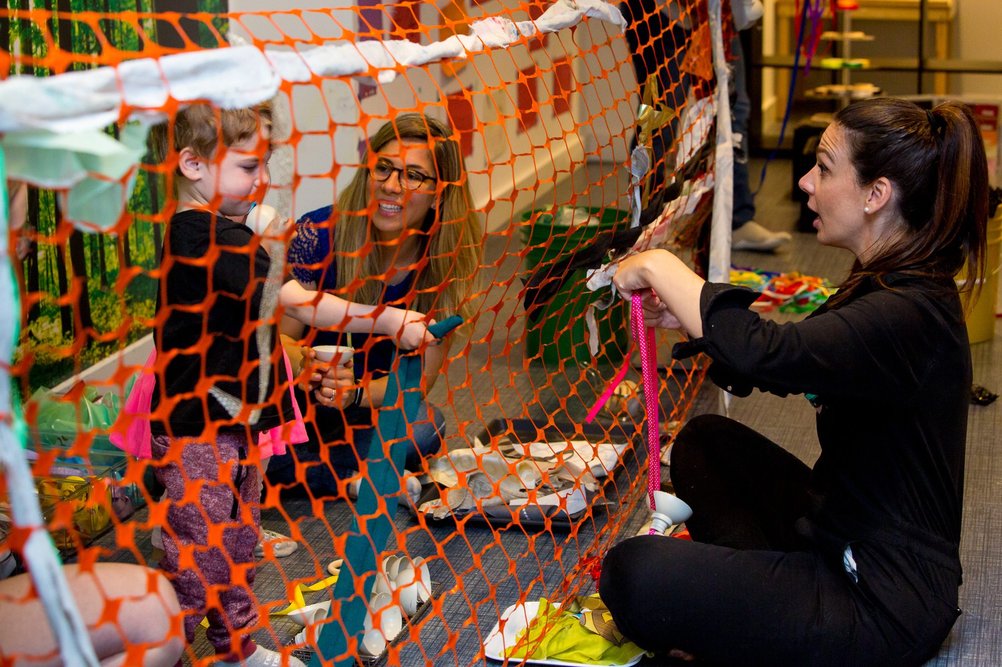 BeSpace facilitators working with a child at a community workshop